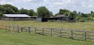 corrals in foreground and outbuildings in the background