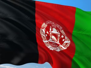 The Afghan flag is a tricolor of vertical stripes: black, red, and green, with the national emblem in the center