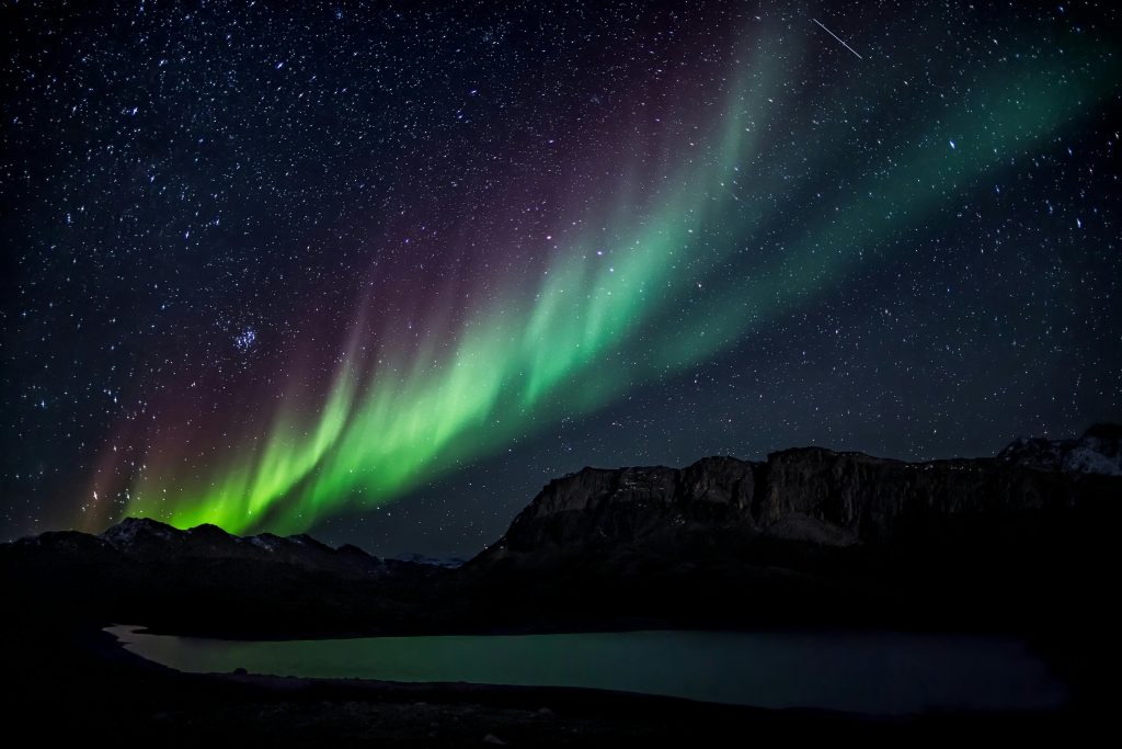 rainbow of lights in a night backdrop over water
